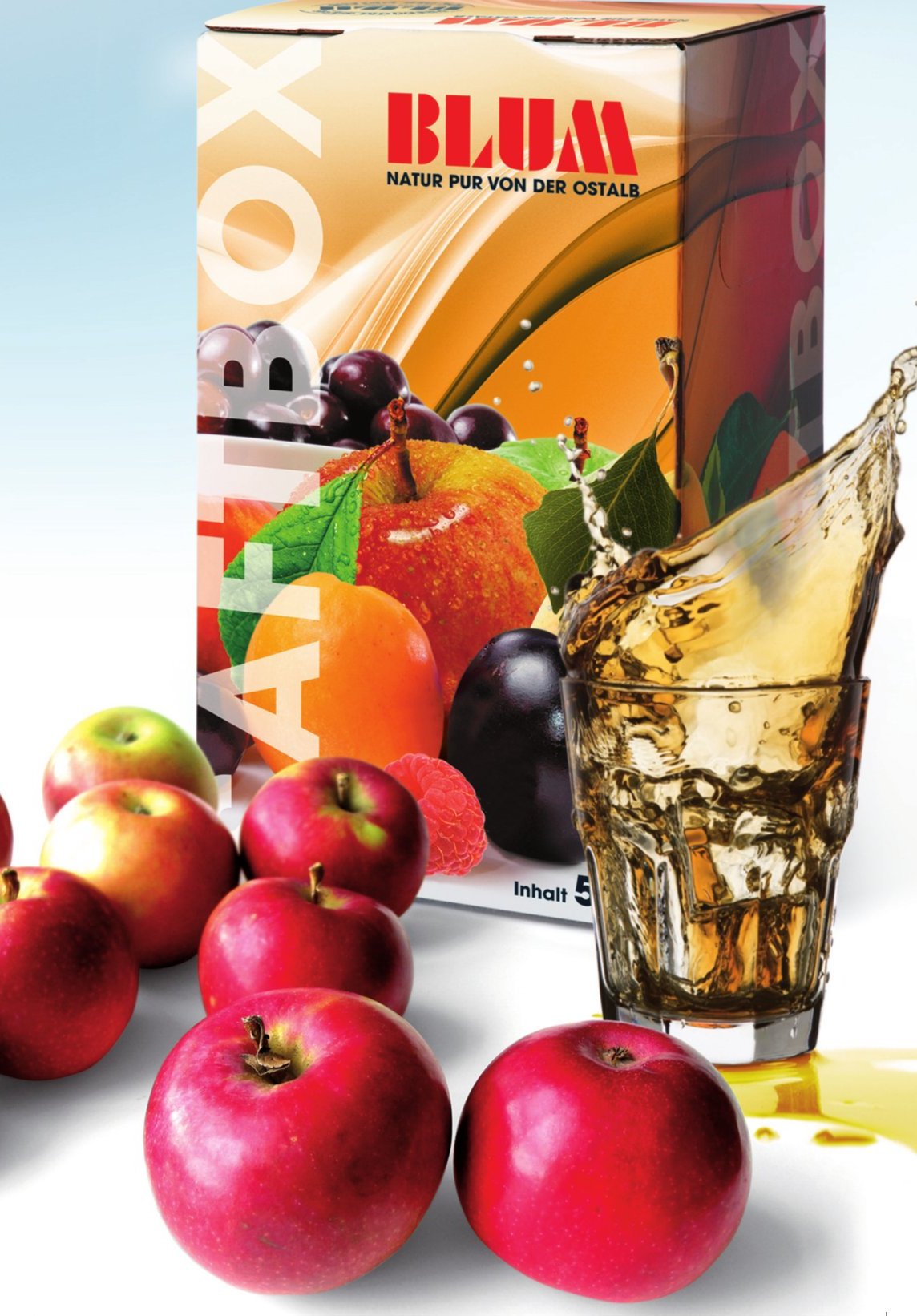 Blum Saft-Box mit frischen roten Äpfeln und einem Glas Apfelsaft